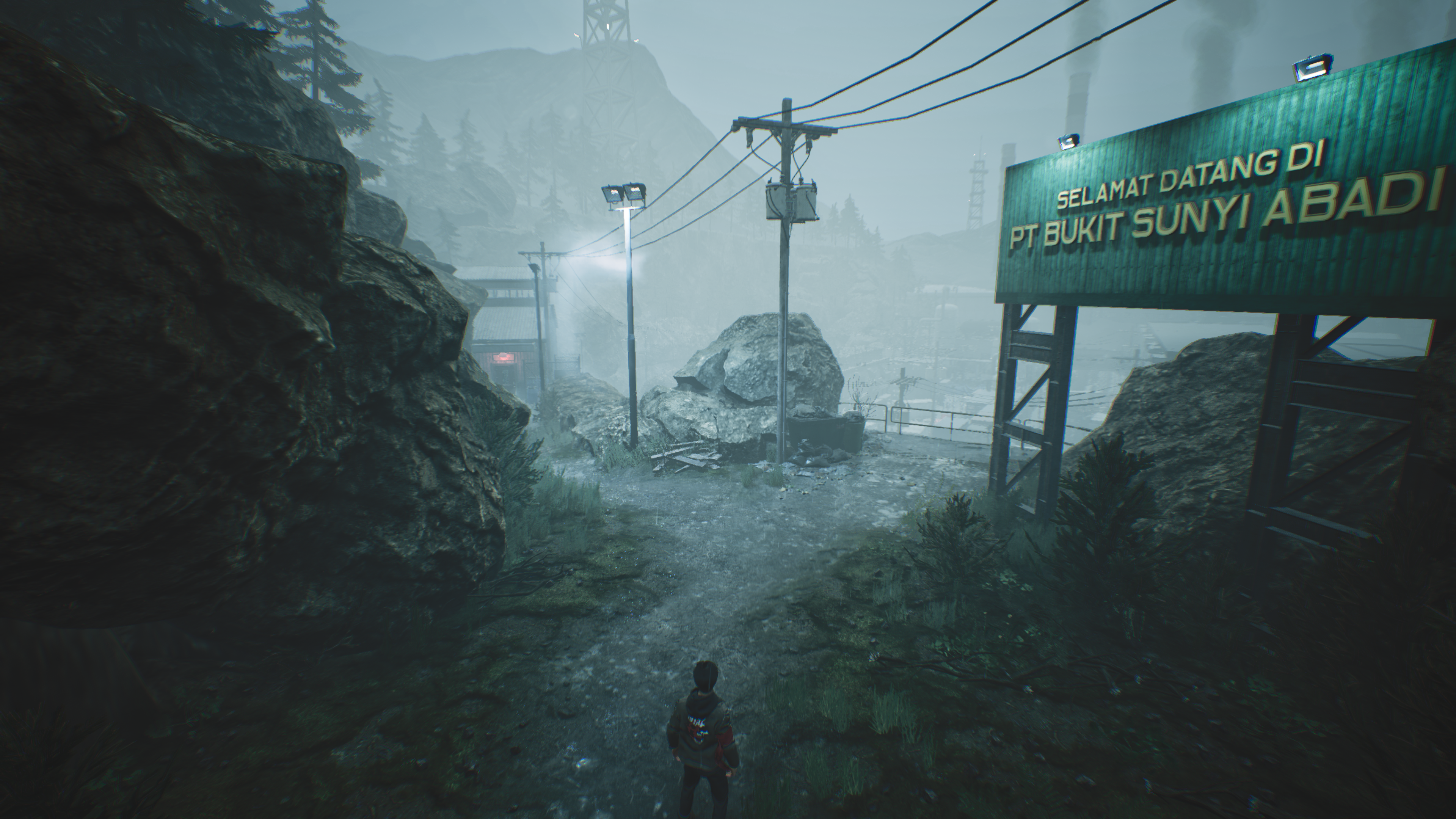 Hendra approaches an industrial site in a misty mountain landscape.
